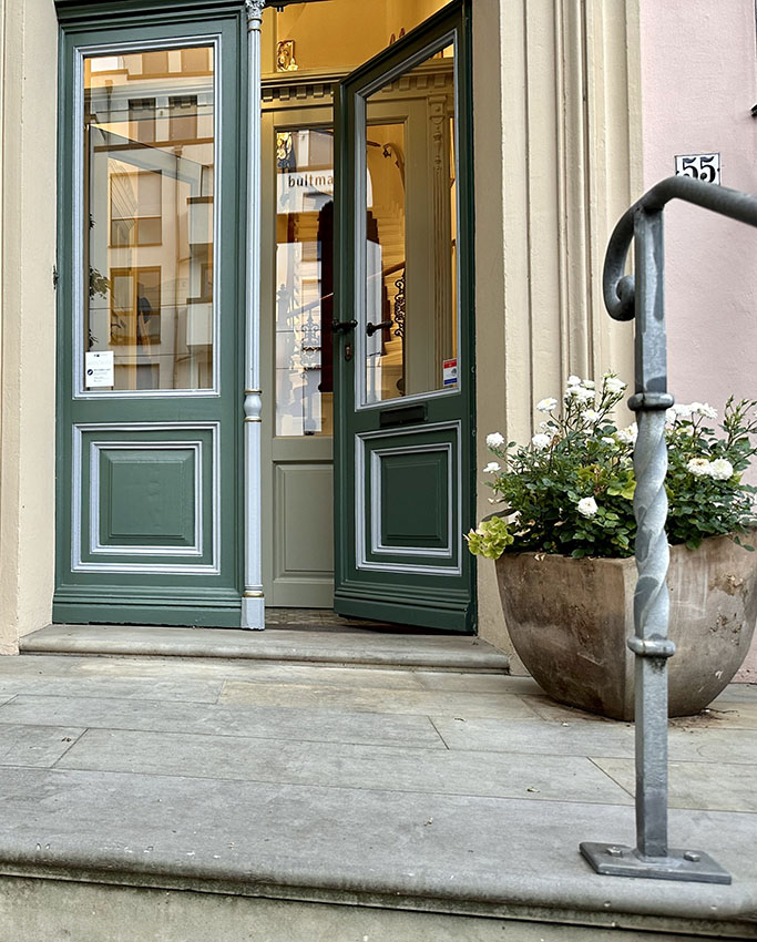 The entrance of the old-town offices, the door standing open as an invitation to come in.