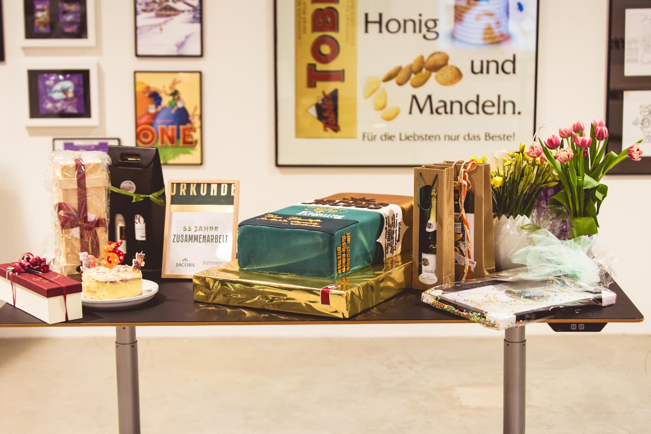 A table with cakes and thank you notes gifted by customers for the 55 years anniversary.